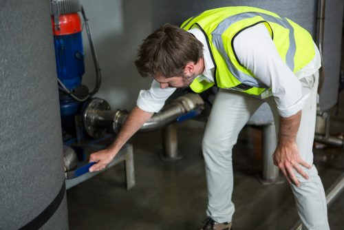 A man working in the filteration plant.